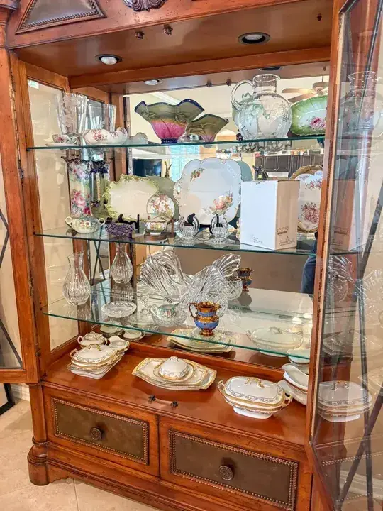 China and glassware displayed in a wooden cabinet