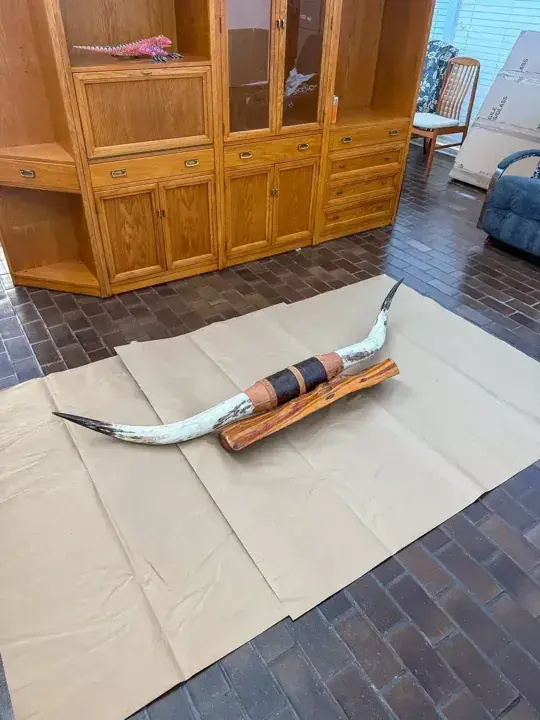 Clock pendulum and long components resting on protective paper