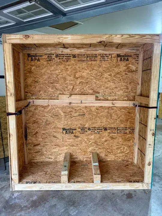 Open wooden crate with internal wooden supports