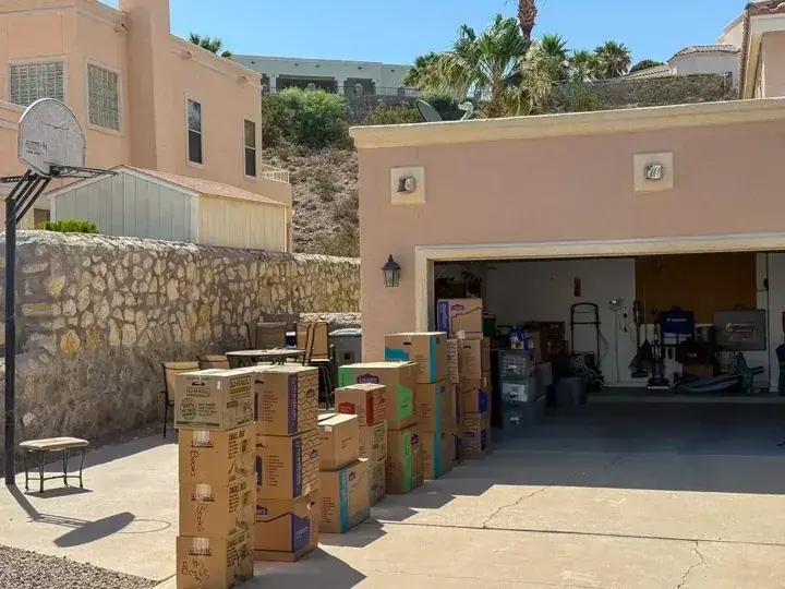 Packed cartons arranged beside an open garage