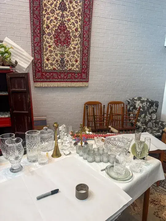Glassware and decorative pieces arranged on a covered dining table