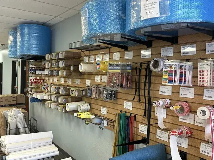 Packing paper, wrap, tape and protective materials on shelves