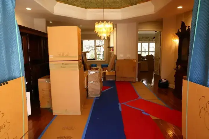 Blue doorway pads and red and blue floor runners through a home