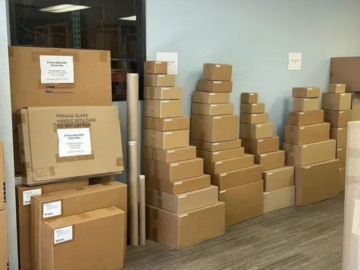 Flat picture boxes and smaller cartons arranged by size