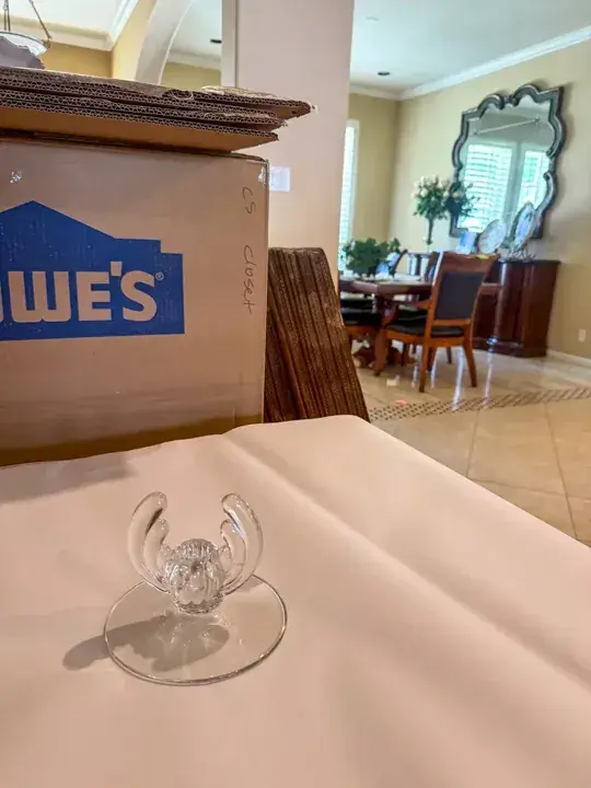 Clear stemmed glass resting on packing paper